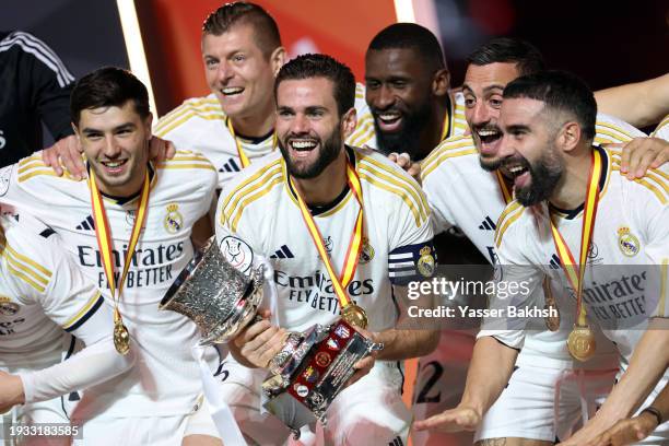 Nacho Fernandez of Real Madrid lifts the Super Copa de España trophy after the team's victory in the Super Copa de España Final match between Real...