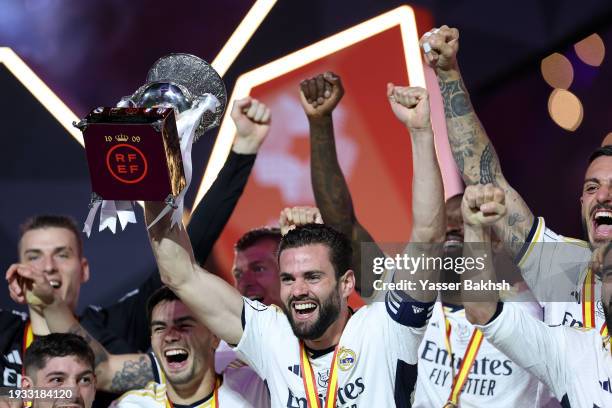 Nacho Fernandez of Real Madrid lifts the Super Copa de España trophy after the team's victory in the Super Copa de España Final match between Real...