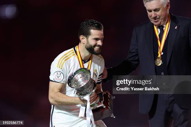 Nacho Fernandez of Real Madrid prepares to lift the Super Copa de España trophy after the team's victory in the Super Copa de España Final match...