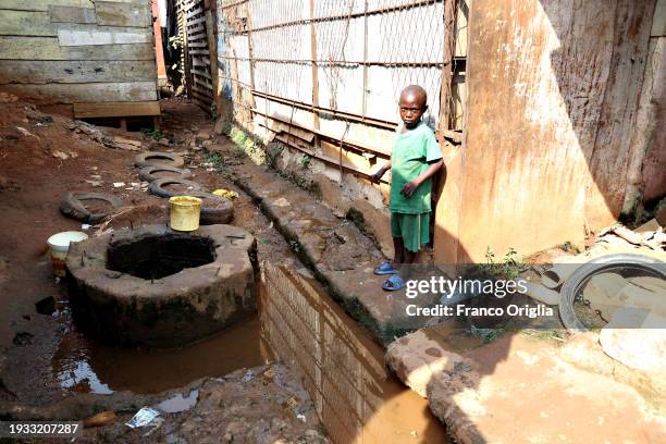 Child poses in a slum on January 14, 2024 in Yaounde, Cameroon. Cameroon is often referred to as 'Africa in miniature' for its geological and...