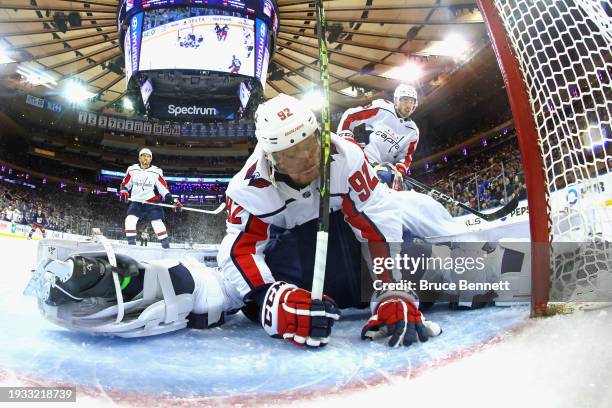 Evgeny Kuznetsov of the Washington Capitals lands on top of Charlie Lindgren of the Washington Capitals during the third period against the New York...