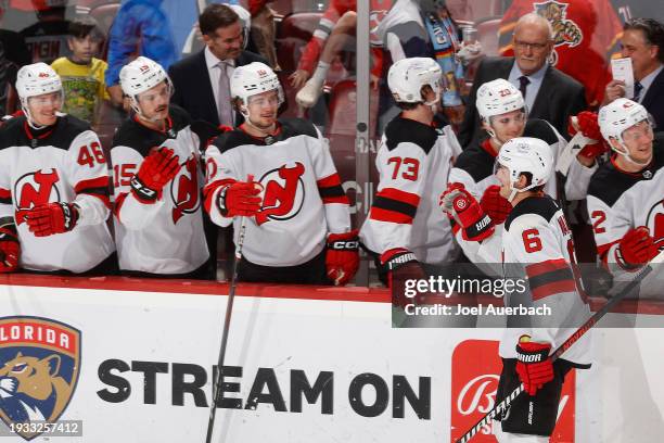 Teammates congratulate John Marino of the New Jersey Devils after he scored a third period goal against the Florida Panthers at the Amerant Bank...