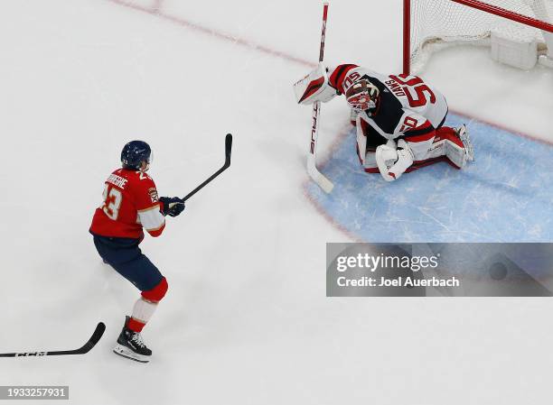 Goaltender Nicolas Daws of the New Jersey Devils stops a shot by Carter Verhaeghe of the Florida Panthers at the Amerant Bank Arena on January 13,...