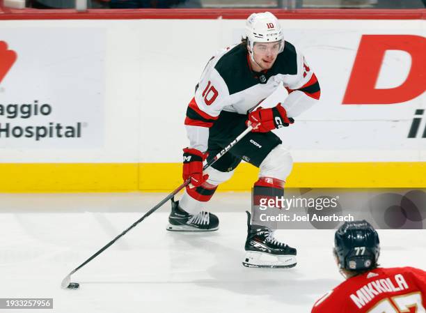 Alexander Holtz of the New Jersey Devils skates with the puck against the Florida Panthers at the Amerant Bank Arena on January 13, 2024 in Sunrise,...