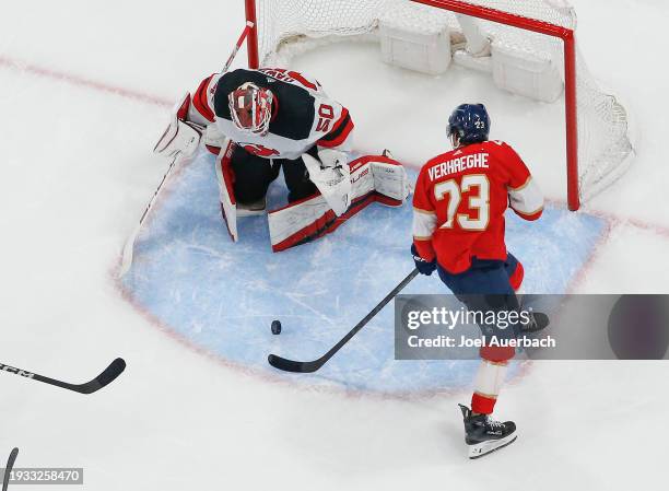 Goaltender Nicolas Daws of the New Jersey Devils stops a shot by Carter Verhaeghe of the Florida Panthers at the Amerant Bank Arena on January 13,...