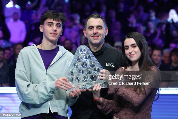 Ronnie O’Sullivan of England poses for a photo alongside Son, Ronnie O'Sullivan Jr and Daughter, Lily O'Sullivan with the Paul Hunter Trophy after...