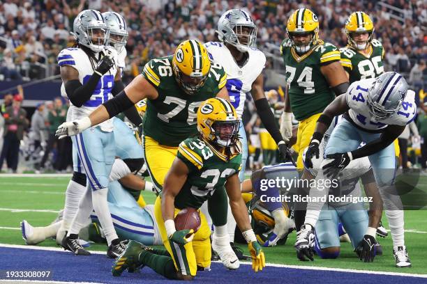 Aaron Jones of the Green Bay Packers rushes for a touchdown against the Dallas Cowboys during the second quarter of the NFC Wild Card Playoff game at...