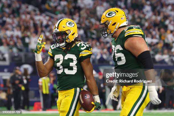 Aaron Jones of the Green Bay Packers celebrates a touchdown with Jon Runyan during the second quarter of the NFC Wild Card Playoff game against the...