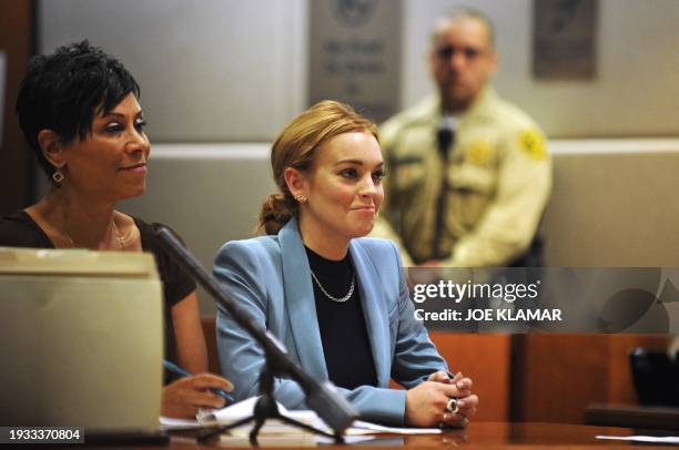 Actress Lindsay Lohan and her attorney Shawn Holley attend a probation progress report hearing at Superior Court in Los Angeles, California, March...