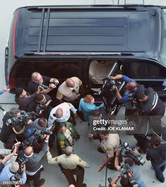 Actress Lindsay Lohan gets in a truck followed by media as she leaves Superior Court in Los Angeles, California after a probation progress report...