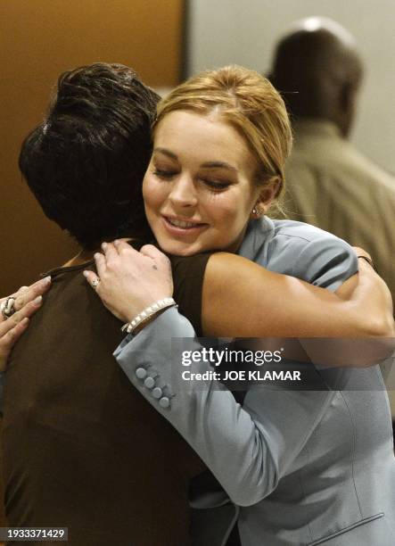 Actress Lindsay Lohan hugs her attorney Shawn Holley at her probation progress report hearing at Superior Court in Los Angeles, California, March 29,...