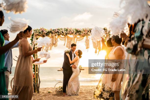 bride and groom in wedding ceremony on the beach - wedding ceremony guests stock pictures, royalty-free photos & images