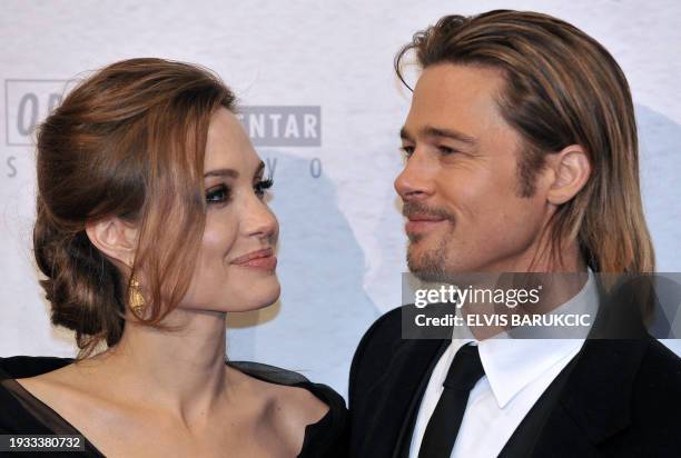 Actress and director Angelina Jolie and her partner Brad Pitt pose on the red carpet during the premiere of her film "In the Land of Blood and Honey"...