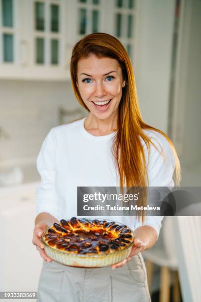 funny fail while baking. smiling woman with burned apple pie - burnt cake stock pictures, royalty-free photos & images