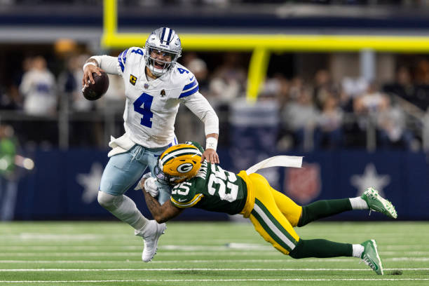 Dak Prescott of the Dallas Cowboys reacts as he's sacked by Keisean Nixon of the Green Bay Packers during an NFL wild-card playoff football game...