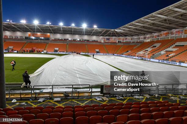 Ground staff work hard to clear snow and ice from the pitch ahead of the Emirates FA Cup Third Round Replay match between Blackpool and Nottingham...