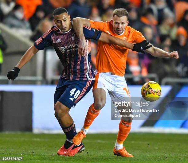 Blackpool's Jordan Rhodes battles with Nottingham Forest's Murillo during the Emirates FA Cup Third Round Replay match between Blackpool and...