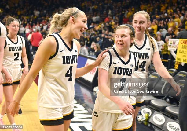 The Iowa women's team is all smiles as they leave the court after winning a college women's basketball game between the Indiana Hoosiers and the Iowa...