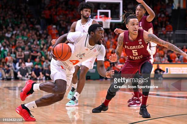 Miami guard Bensley Joseph drives to the basket while defended by FSU forward De'Ante Green in the first half as the Miami Hurricanes faced the...