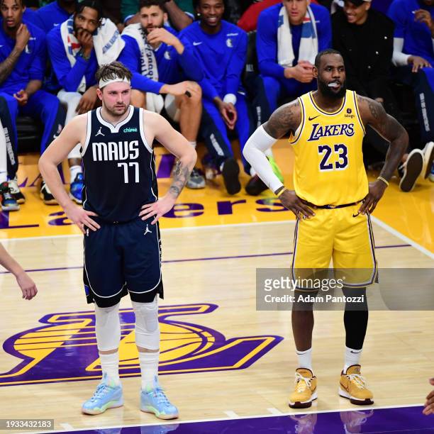Luka Doncic of the Dallas Mavericks and LeBron James of the Los Angeles Lakers look on during the game on January 17, 2024 at Crypto.Com Arena in Los...