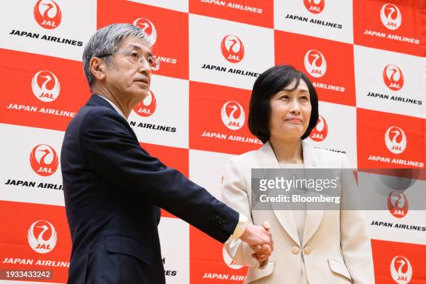 Mitsuko Tottori, incoming president of Japan Airlines Co., right, and Yuji Akasaka, outgoing president, pose for photographs during a news conference...
