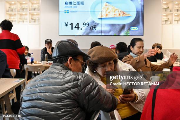 This photo taken on December 5, 2023 shows elderly people at the Ikea restaurant, where they meet every Tuesday, in the Xuhui district in Shanghai....