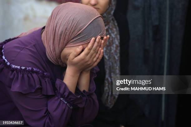 Palestinians mourn the death of loved ones following Israeli bombardment on January 18 in Rafah in the southern Gaza Strip, amid ongoing battles...