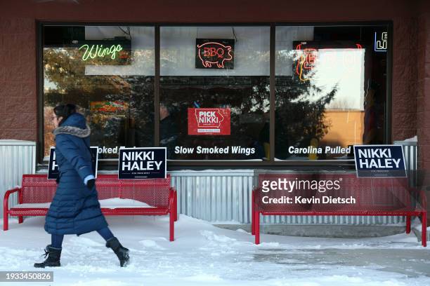 Person walks past campaign signs outside an event for Republican presidential candidate former U.N. Ambassador Nikki Haley at Jethro's BBQ on January...