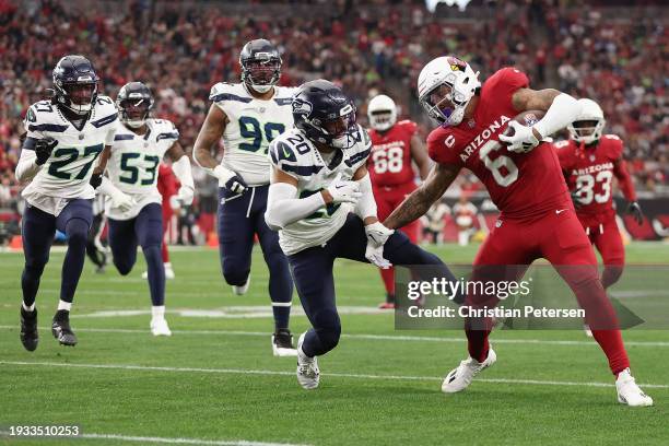 Running back James Conner of the Arizona Cardinals rushes the football against safety Julian Love of the Seattle Seahawks during the first half of...