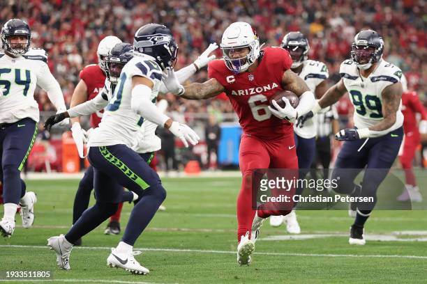 Running back James Conner of the Arizona Cardinals rushes the football against safety Julian Love of the Seattle Seahawks during the first half of...