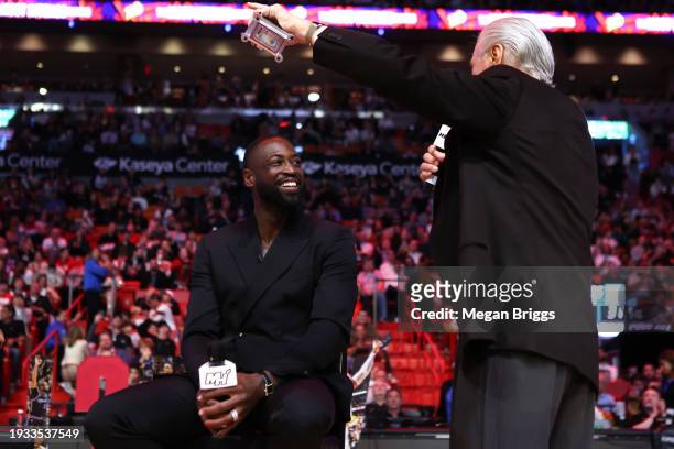 Miami Heat president Pat Riley and former Miami Heat player Dwayne Wade address the crowd during a Hall of Fame ceremony at halftime between the...