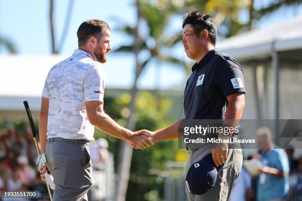 Chris Kirk of the United States and Byeong Hun An of South Korea embrace after completing their round on the 18th green during the final round of the...