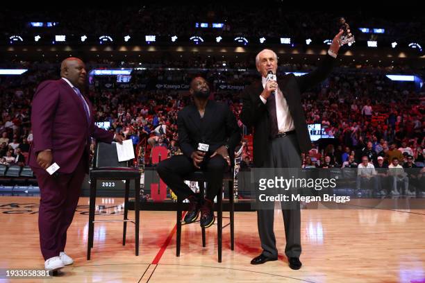 Miami Heat president Pat Riley and former player Dwayne Wade address the crowd during a Hall of Fame ceremony at halftime of a game between the Heat...