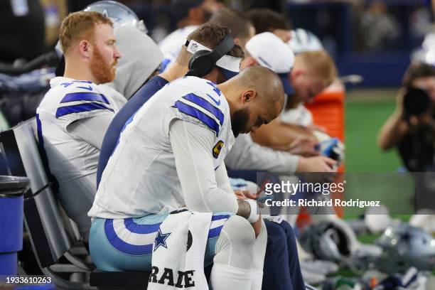 Dak Prescott of the Dallas Cowboys sits on the bench during the fourth quarter of the NFC Wild Card Playoff game against the Green Bay Packers at...