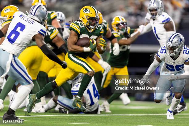 Aaron Jones of the Green Bay Packers runs with the ball for a touchdown during an NFL wild-card playoff football game between the Dallas Cowboys and...