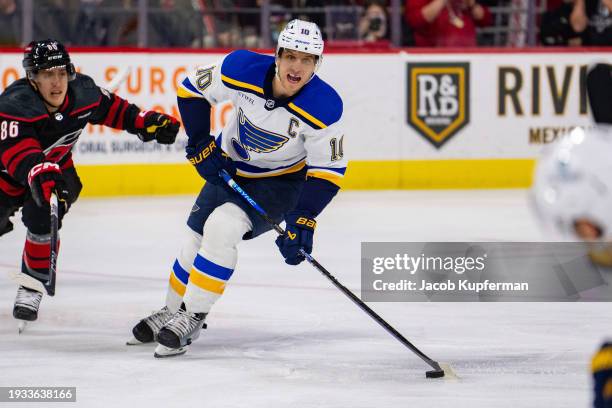 Brayden Schenn of the St. Louis Blues brings the puck up the ice against the Carolina Hurricanes during their game at PNC Arena on January 06, 2024...