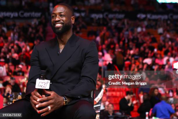 Former Miami Heat player Dwayne Wade attends his Hall of Fame induction ceremony at halftime against the Charlotte Hornets at Kaseya Center on...