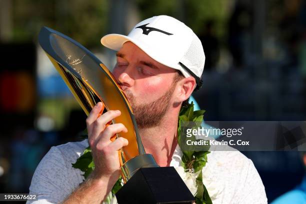 Grayson Murray of the United States poses with the championship trophy after victory on the first play-off hole during the final round of the Sony...