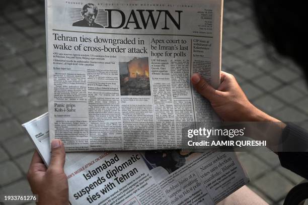 Man reads the frontpage of the Pakistani English-language newspaper Dawn displaying news on Iran's airstrike, in Islamabad January 18, 2024. Pakistan...