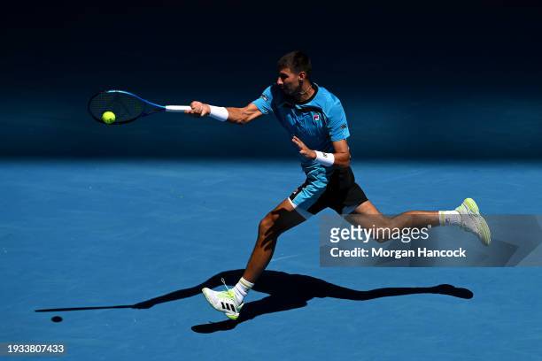 Alexei Popyrin of Australia plays a forehand in their round one singles match against Marc Polmans of Australia during the 2024 Australian Open at...