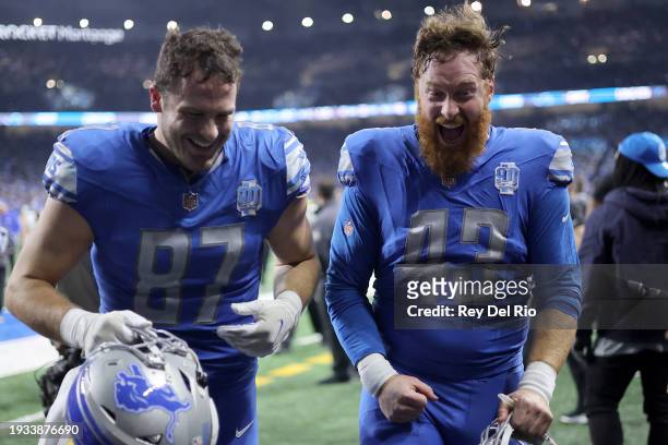 Sam LaPorta and Jake McQuaide of the Detroit Lions celebrate after defeating the Los Angeles Rams 24-23 in the NFC Wild Card Playoffs at Ford Field...