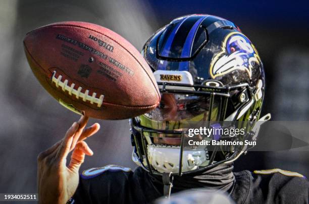 Baltimore Ravens quarterback Lamar Jackson twirls a football pregame as the Ravens prepare to host the Miami Dolphins at M&T Bank Stadium in...