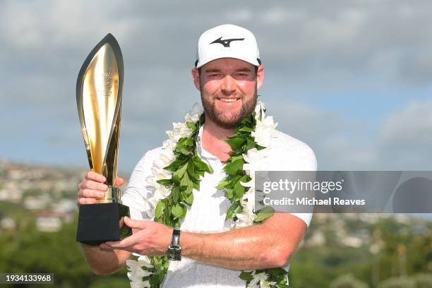 Grayson Murray of the United States poses with the trophy after winning the Sony Open in Hawaii on the first play-off hole at Waialae Country Club on...