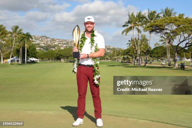 Grayson Murray of the United States poses with the trophy after winning the Sony Open in Hawaii on the first play-off hole at Waialae Country Club on...