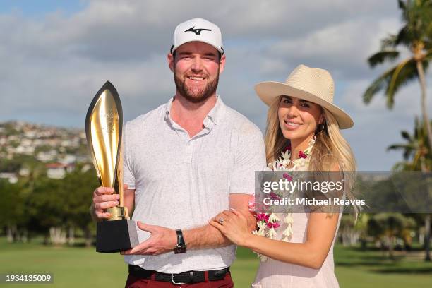 Grayson Murray of the United States and fiancee, Christiana, pose for a photo with the trophy after winning the Sony Open on the first playoff hole...