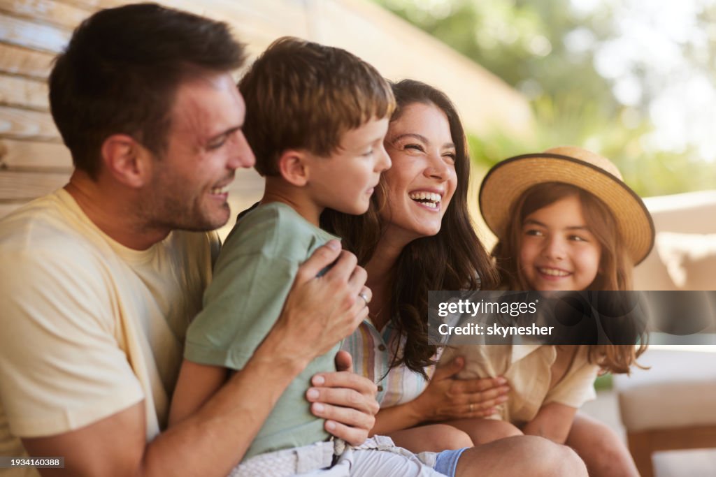 Cheerful family enjoying in summer day on a patio.