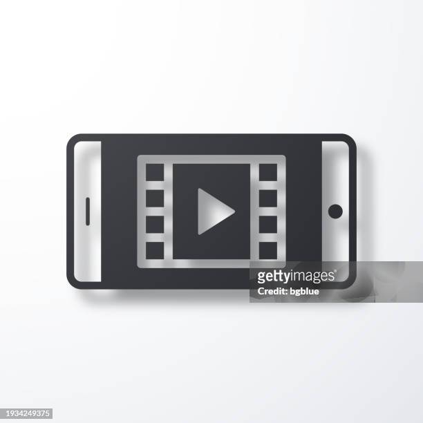 watch video on smartphone. icon with shadow on white background - netflix stock illustrations