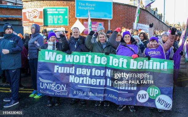 Medical staff stand on a picket line outside the Royal Victoria Hospital in Belfast on January 18 as tens of thousands of public sector works took...