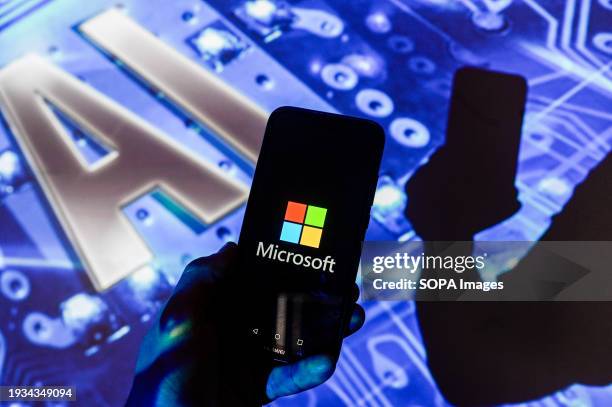 In this photo illustration, a Microsoft logo is displayed on a smartphone with Artificial Intelligence symbol in the background.
