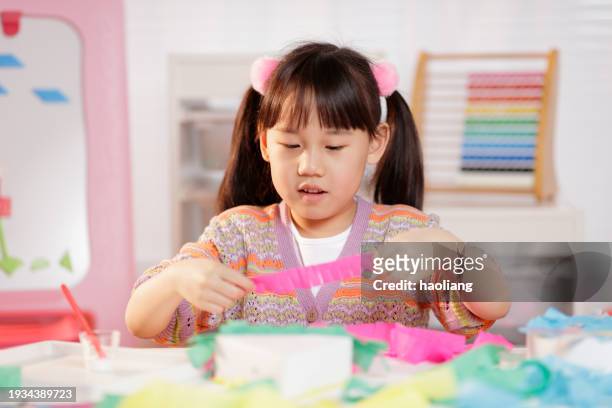 young girl making craft at home - six year old stock pictures, royalty-free photos & images